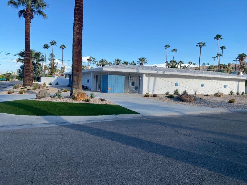 Restored mid-century street frontage with mountains beyond