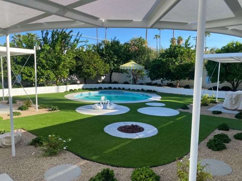 Pool, lawn and shaded patio of the renovated home