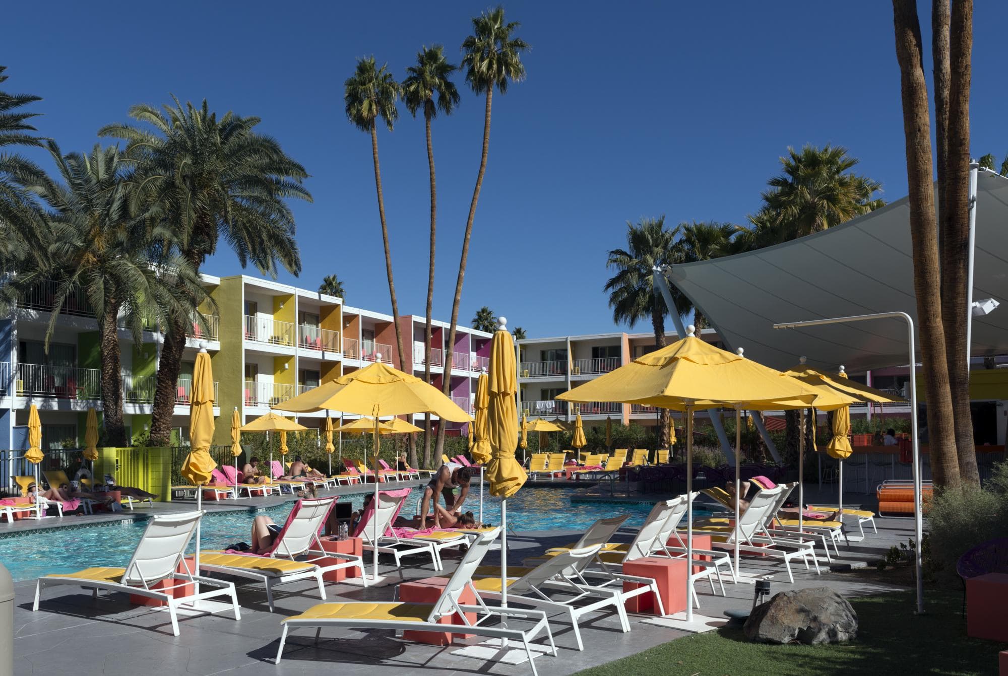 Saguaro pool with yellow umbrellas and loungers