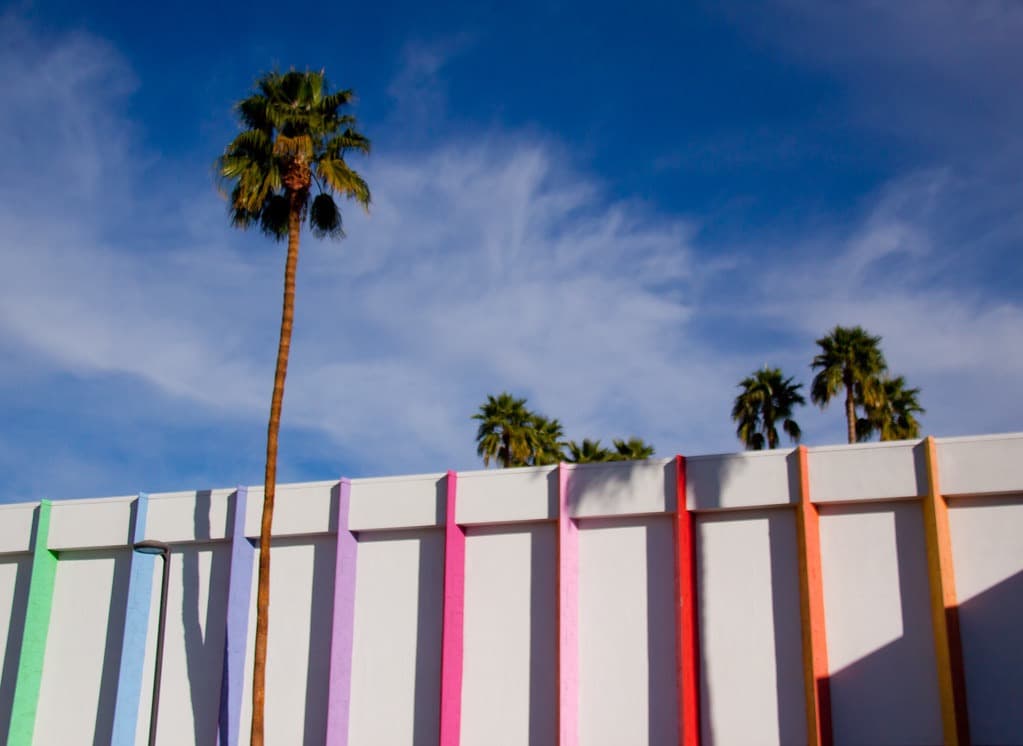 Vertical rainbow color stripes of the Saguaro façade against a blue sky