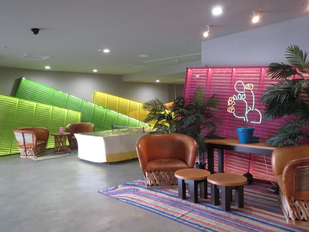 Saguaro lobby with neon cactus sculptures and louvered walls